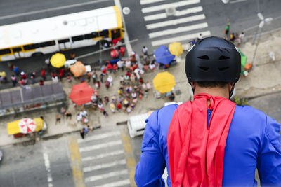 Man dressed as a superhero rappelling down from a tall building. salvador bahia brazil.