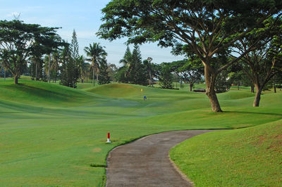 Scenic view of golf course against sky