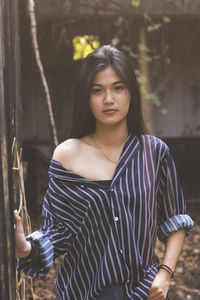 Portrait of young woman standing outdoors