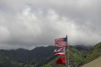 Flag on mountain against sky