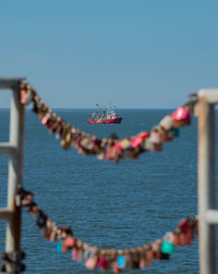 View of boats in sea against clear sky