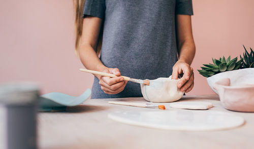 Midsection of woman working on table