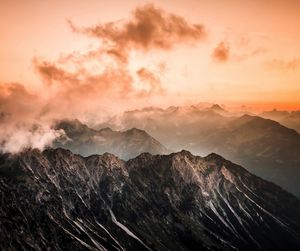 Scenic view of mountains against sky at sunset