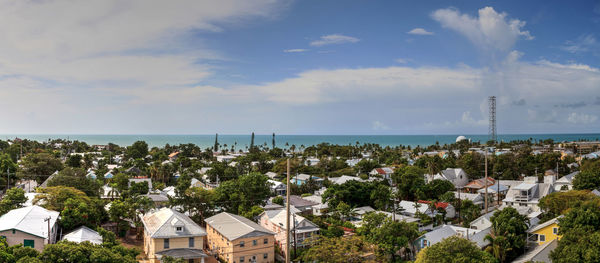 High angle view of townscape by sea against sky