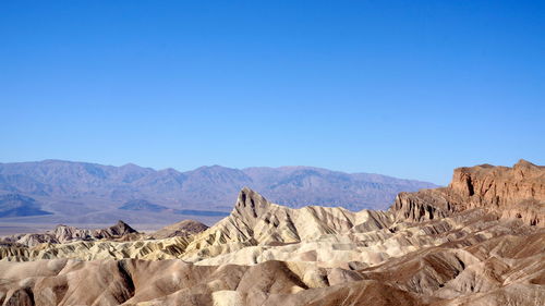 Scenic view of mountains against clear blue sky