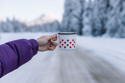 Cropped hand of woman holding coffee