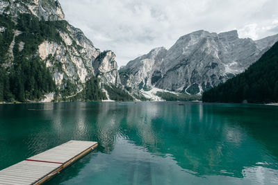 Scenic view of lake by mountains against sky