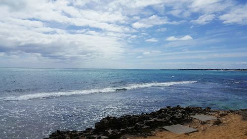 View of calm sea against cloudy sky