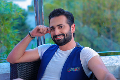 Portrait of smiling young man standing outdoors