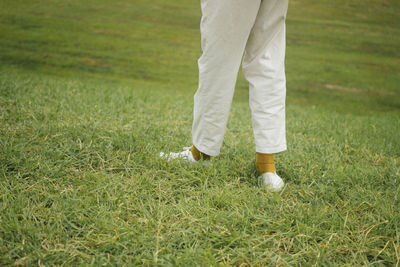 Low section of man standing on golf course