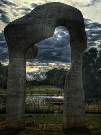 Scenic view of grassy field against cloudy sky