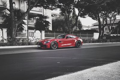 Red car on street in city