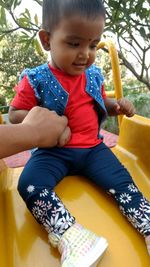 Boy sitting in park