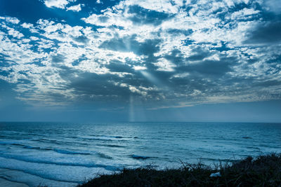 Scenic view of sea against cloudy sky