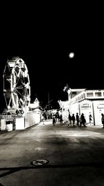 Illuminated ferris wheel at night