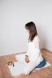 Woman sitting on table at home