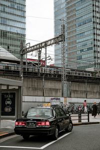 Cars on street by buildings in city