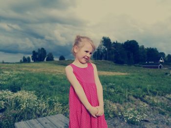 Portrait of girl standing on field