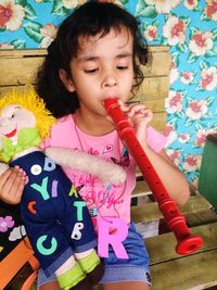 Cute girl playing with toys on bench