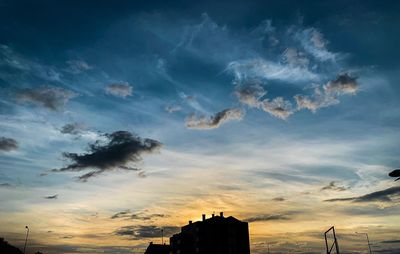 Low angle view of silhouette buildings against sky during sunset