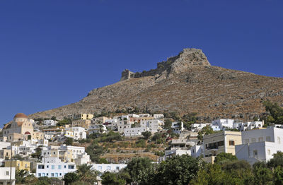 Low angle view of buildings against clear blue sky