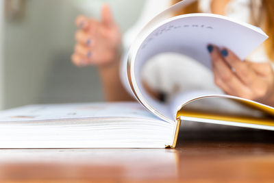 Close-up of hand holding book