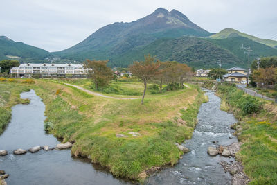 Scenic view of river amidst mountains against sky