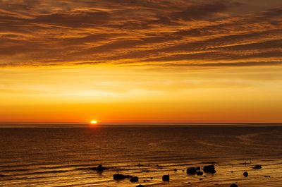 Scenic view of sea against orange sky