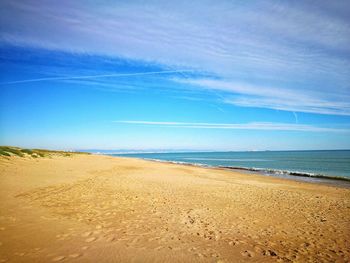 Scenic view of beach against blue sky