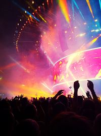 Group of people in front of firework display