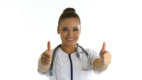 Portrait of smiling young woman against white background