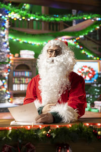 Rear view of woman holding christmas tree