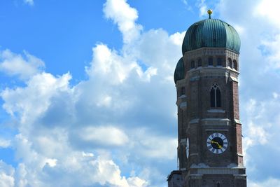 Low angle view of clock tower against cloudy sky