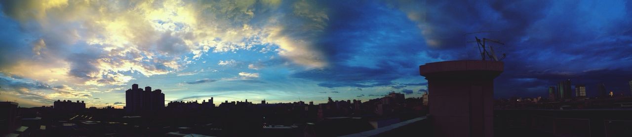 building exterior, sky, architecture, cloud - sky, built structure, cloudy, city, sunset, silhouette, dramatic sky, cloud, weather, cityscape, dusk, storm cloud, tower, building, overcast, skyscraper, tall - high