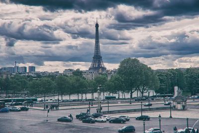 View of cityscape against cloudy sky