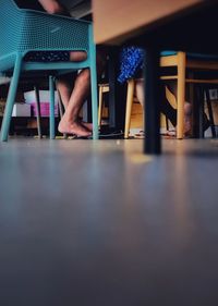 Low section of people sitting on chair