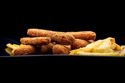 Close-up of bread in container against black background