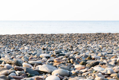 Stones on beach against sky