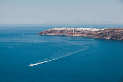 Boat sailing in sea against sky