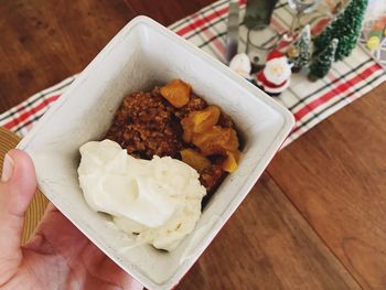 High angle view of hand holding food on table