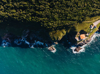 Aerial view of house by sea