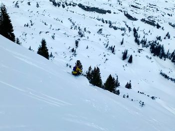 High angle view of man skiing on snow covered land