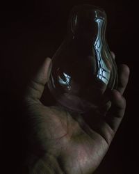 Close-up of hands over black background