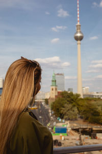 Woman looking at fernsehturm in city