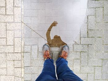 Low section of woman standing on tiled floor