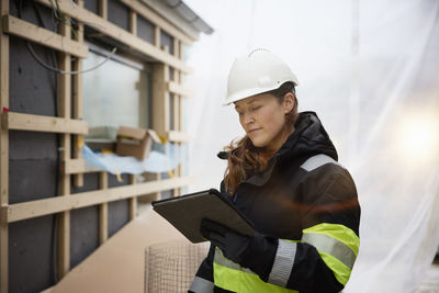 Female engineer using digital tablet at building site