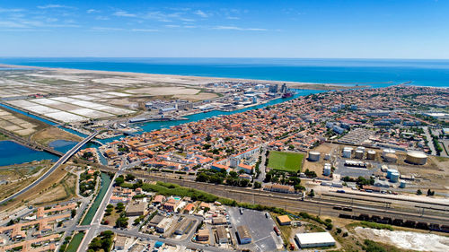 High angle view of buildings by sea against sky