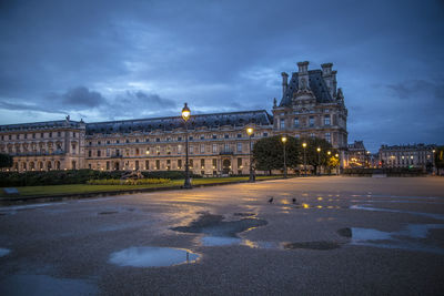 View of illuminated building against cloudy sky