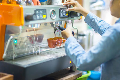 Midsection of man working in kitchen