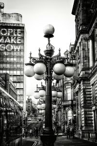 Street lights in city against sky